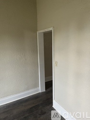 A room with a door and a wall.