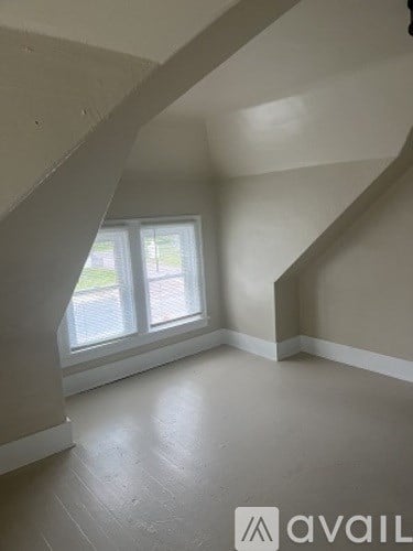 A room with a staircase and a window.