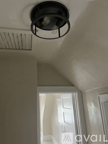 A light fixture is mounted on a white ceiling.