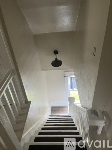 A staircase with a light hanging from the ceiling.