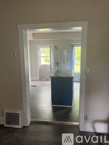 A room with a white door and a blue cabinet.