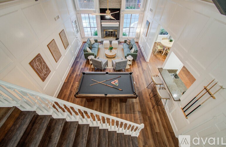 A large, well-furnished living room with a pool table.