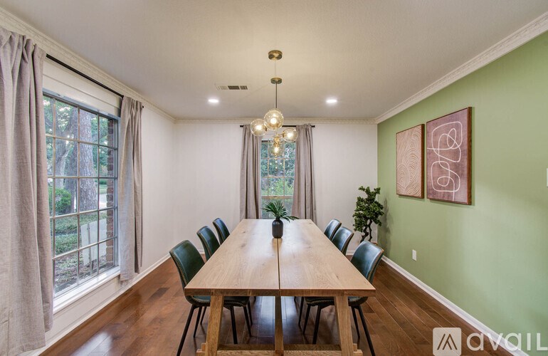A dining room with a long table and chairs.