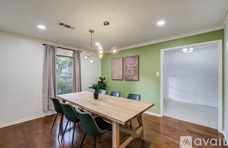 A dining room with a wooden table and chairs.