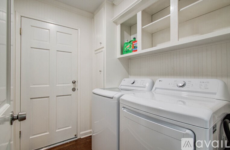 A white door is on the left and a white washing machine is on the right.