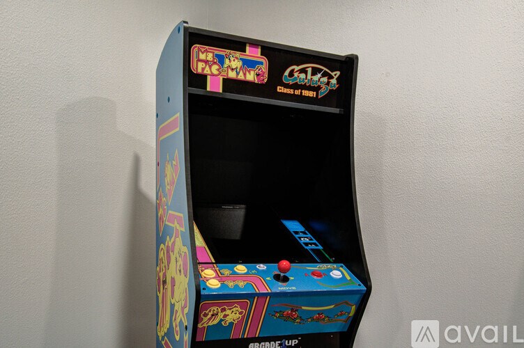 A small arcade machine with a blue and yellow design.