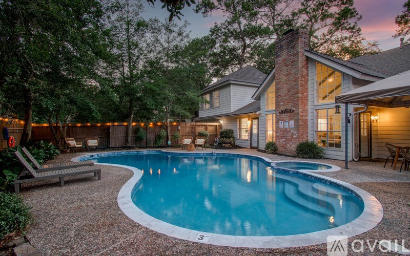 A backyard with a pool and a house.