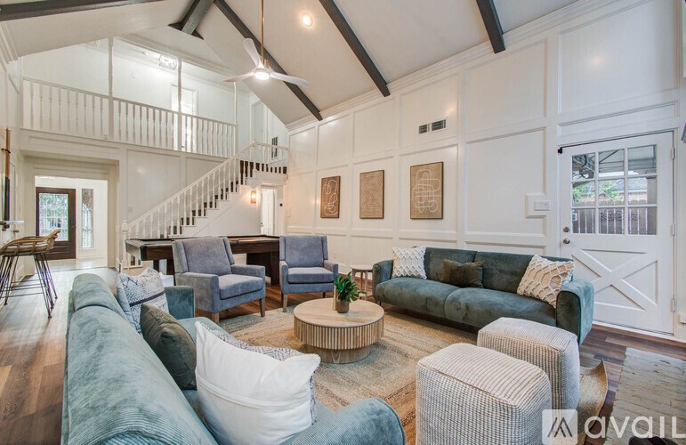 A living room with a staircase and a couch.