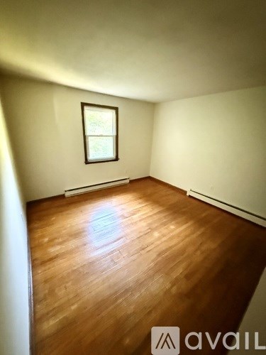 A room with wooden floors and a window.