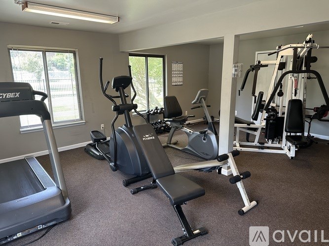 A gym with treadmills, elliptical machines, and other exercise equipment.
