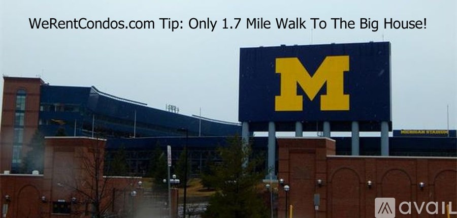A large blue sign with a yellow "M" is displayed in front of a building.