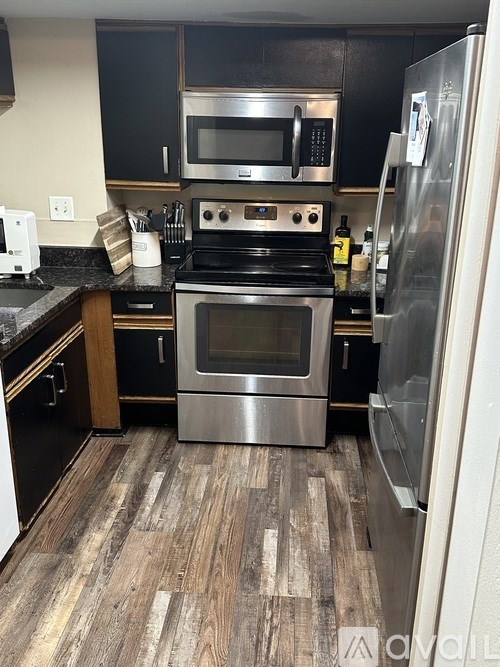 A kitchen with a stove top oven and a microwave above it.
