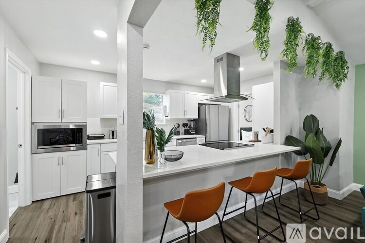 A modern kitchen with white cabinets and a large island.