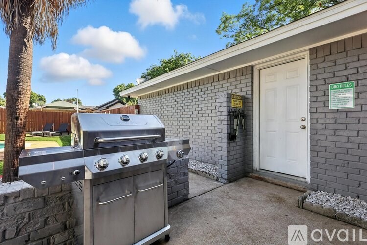 A house with a grill in front of it.