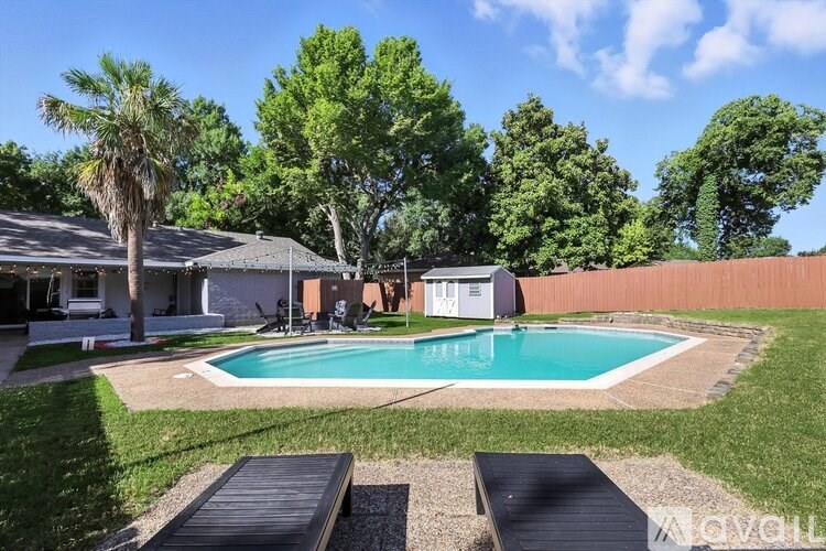 A backyard with a pool and a deck.