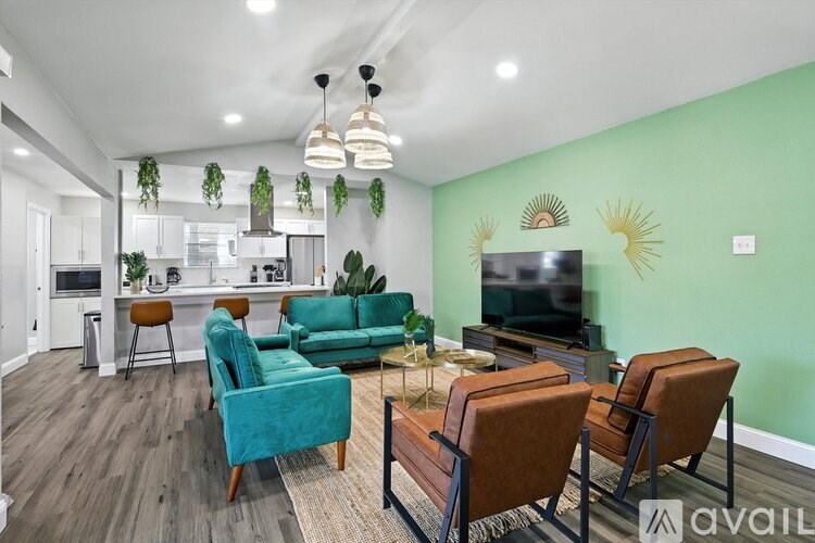 A living room with a green wall and a television.
