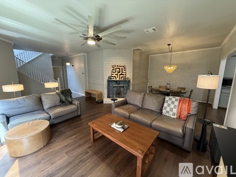 A living room with a wooden coffee table and grey couches.