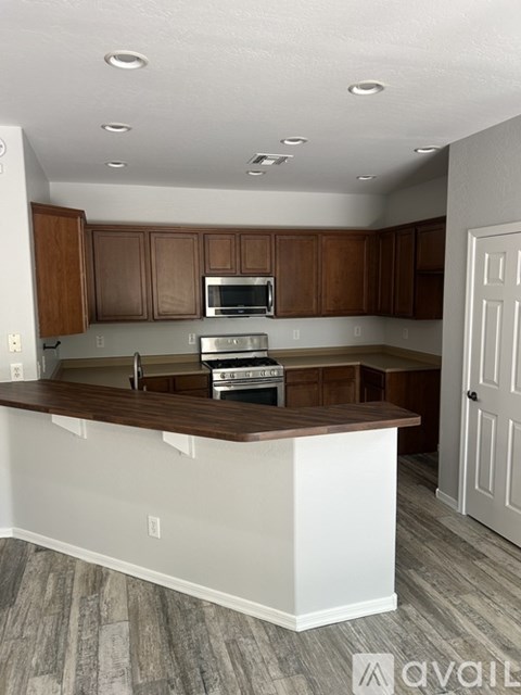 A kitchen with brown cabinets and a white island.