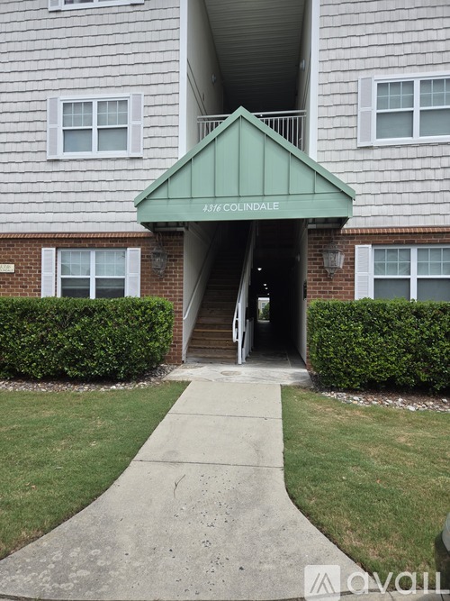 The front of a building with a green awning that says "1316 COLDNALD".