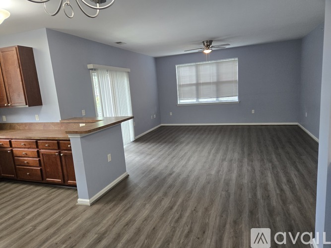 A spacious kitchen with wooden floors and a large island.