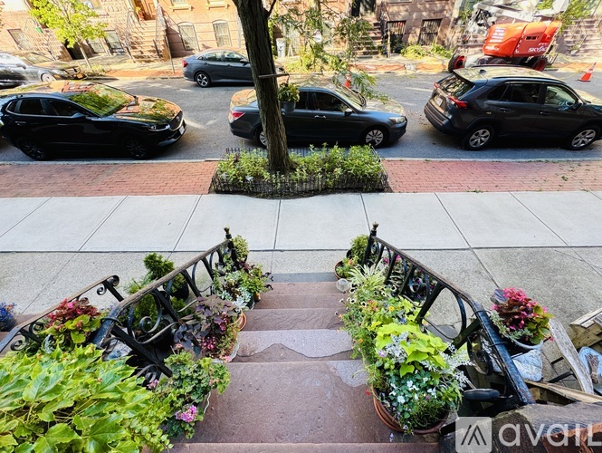 A black car is parked on the side of a street.