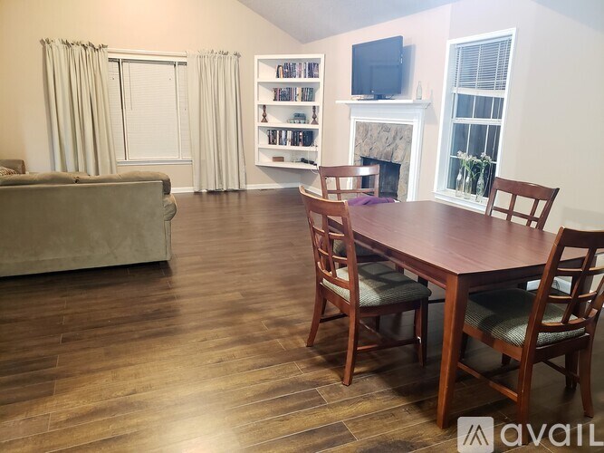 A living room with a couch, a fireplace, and a television.