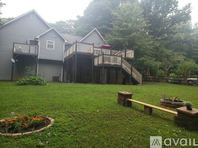 A house with a deck and a garden in front.