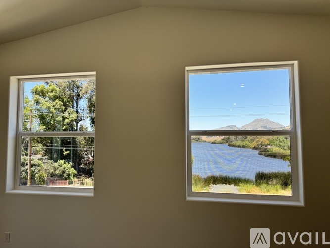 Two framed pictures of landscapes are hanging on a wall.
