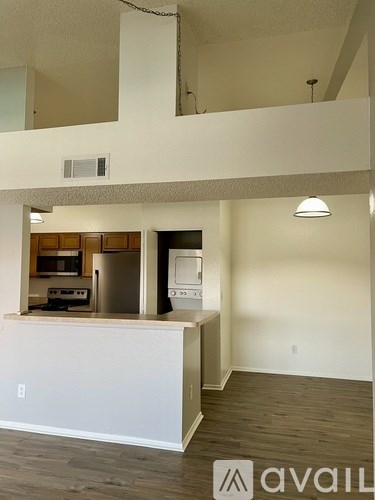 A kitchen area with a counter and cabinets.