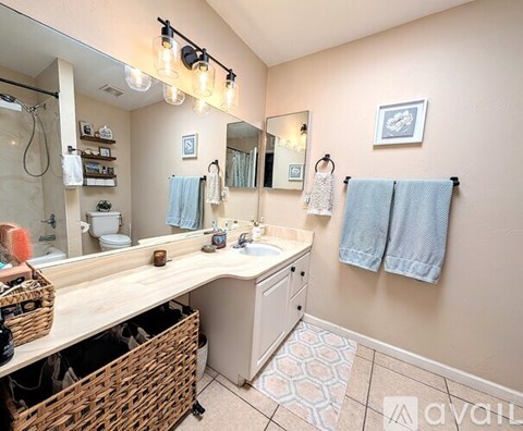 A kitchen with wooden cabinets and a stainless steel refrigerator.