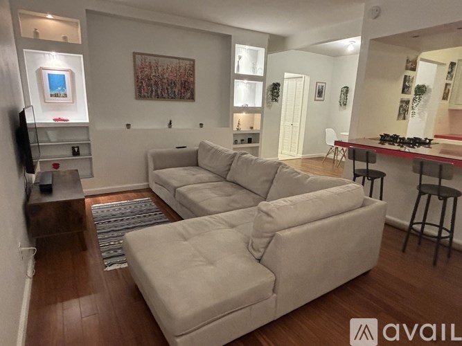 A living room with a large couch and a television.