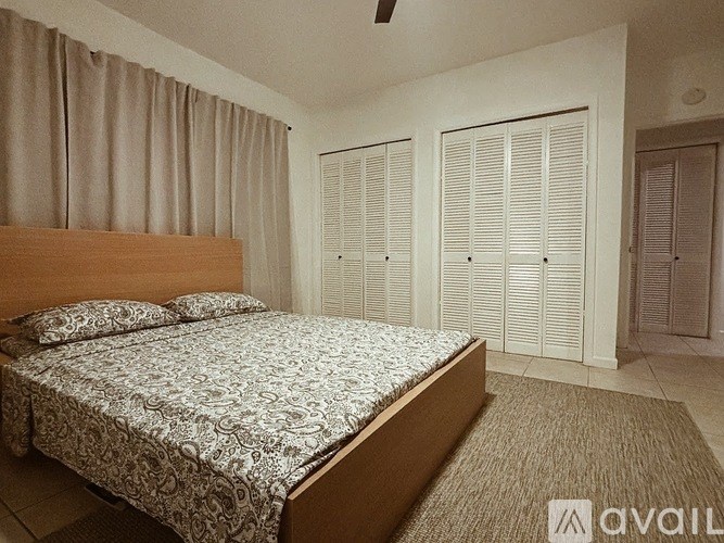 A kitchen with white cabinets and a red countertop.
