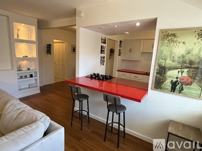A bedroom with a large bed and a ceiling fan.
