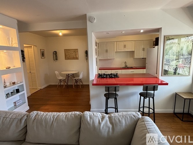 A bathroom with a green sink and a glass shower stall.