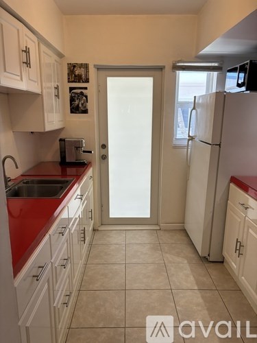 A balcony of a building with a palm tree in the center.