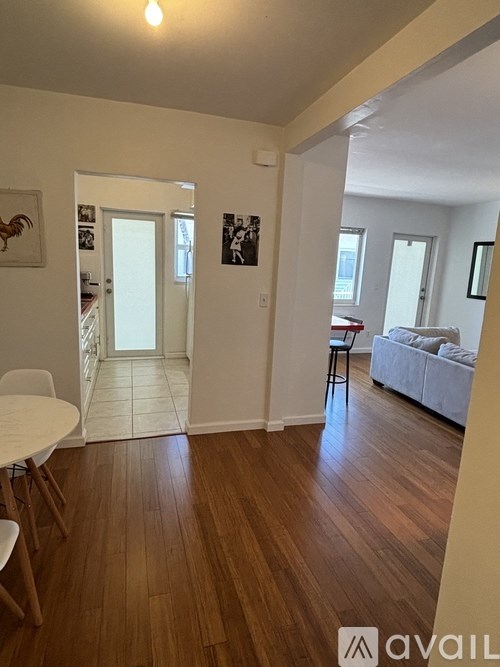 A beachfront cityscape with a yellow arrow pointing to a tall building.