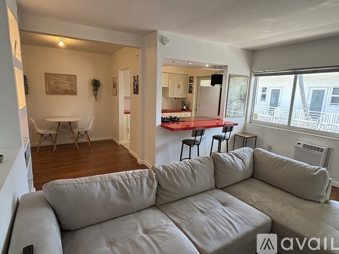 A beachfront cityscape with a yellow arrow pointing to a specific building.