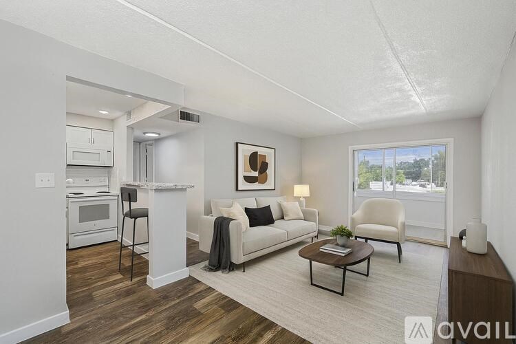 A living room with a couch, chair, and coffee table.