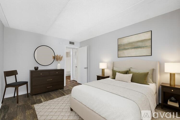 A room with wooden flooring and a window with blinds.
