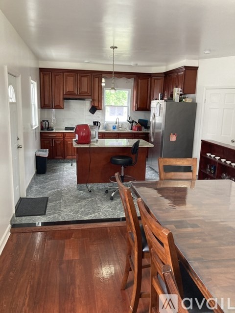 A kitchen with wooden cabinets and a refrigerator.