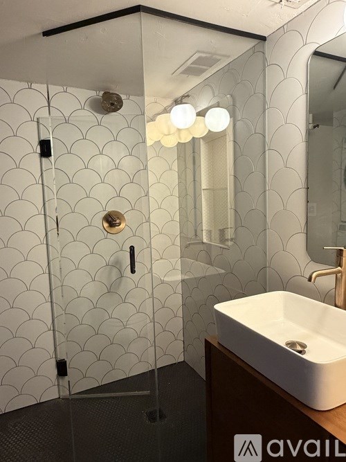 A white toilet in a bathroom with a floral mural on the wall.