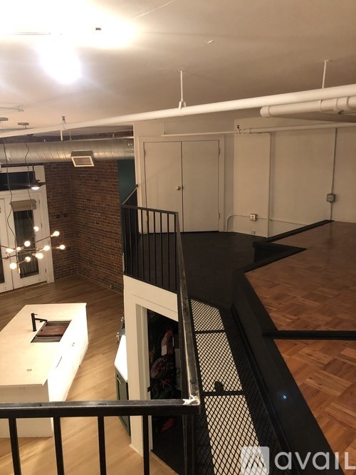 A room with a black railing and a white counter.