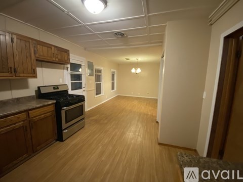 A kitchen with wooden cabinets and a black stove top oven.