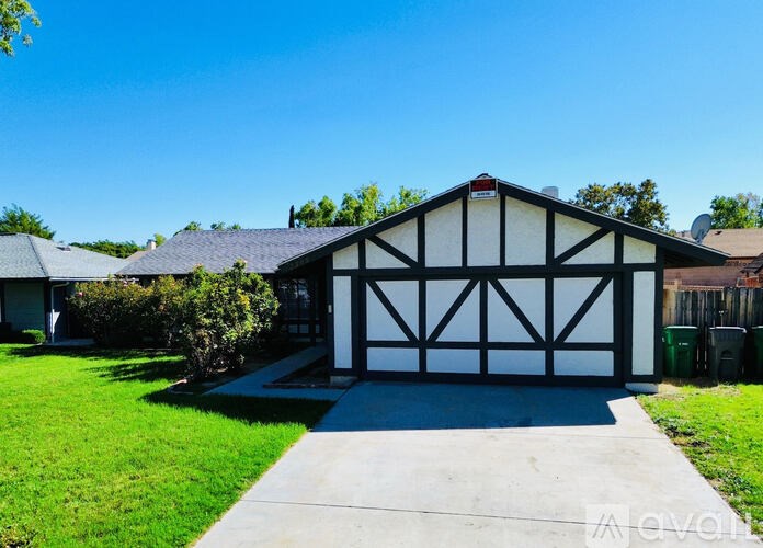 A black and white garage with a clear blue sky above.