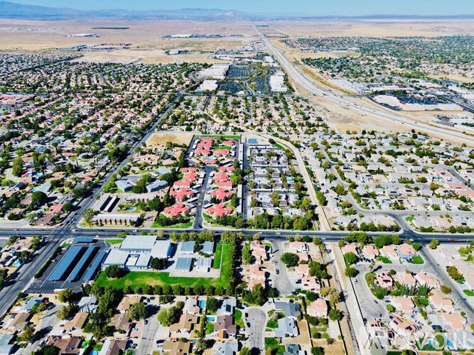 A bird's eye view of a residential area with a road running through it.