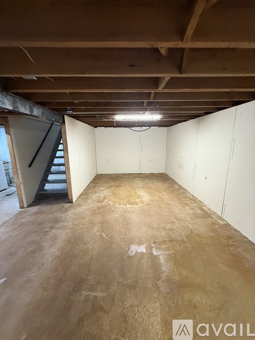 A spacious garage with a concrete floor and white walls.