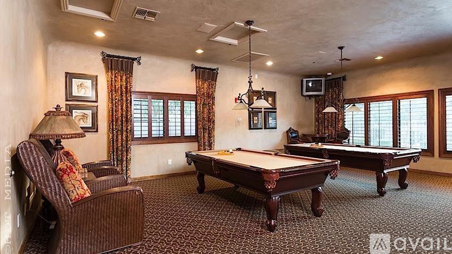 A room with a pool table and a couch.