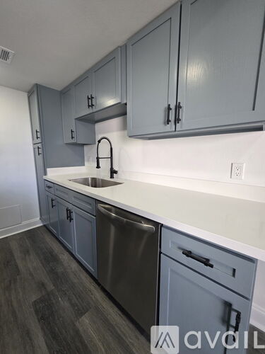 A kitchen with wooden cabinets and appliances.