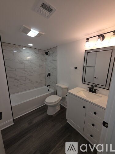 A bathroom with a toilet, sink, and shower.