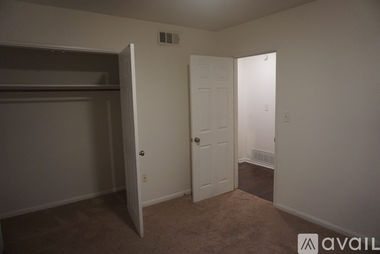 A room with a white door and a white wall.